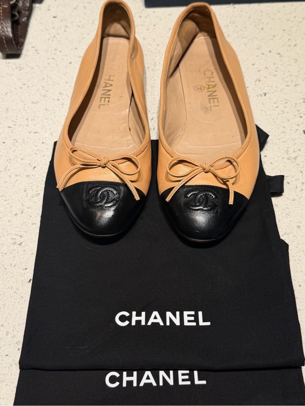 CHANEL Two-Tone Leather Cap-Toe Ballet Flats in Tan and Black